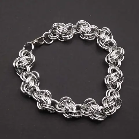 Bright silver aluminum chain mail bracelet on a grey background.