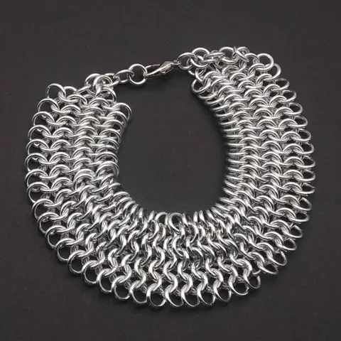 Bright silver aluminum chain mail bracelet on a dark grey background.