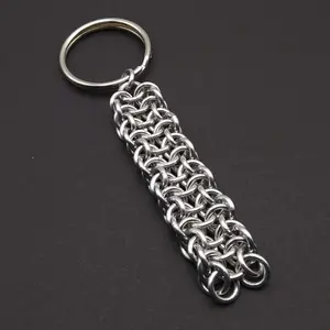 Bright silver aluminum chain mail keychain on a dark grey background.