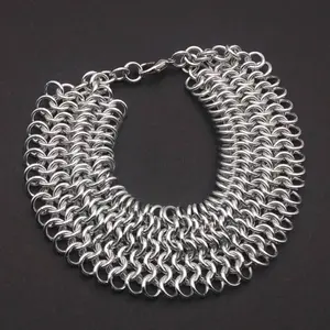 Bright silver aluminum chain mail bracelet on a dark grey background.