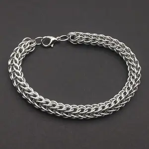 Bright silver aluminum chain mail bracelet on a dark grey background.